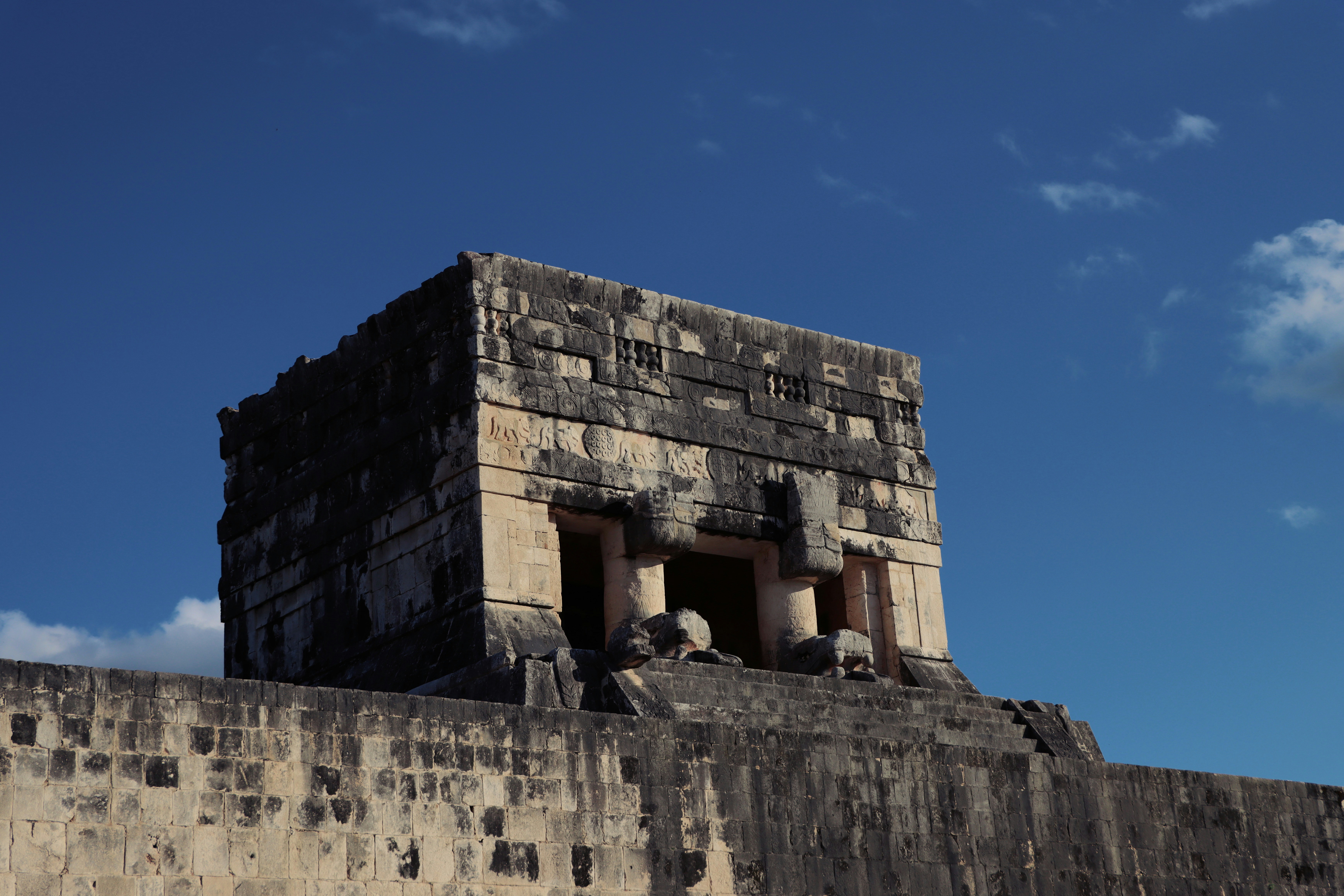 a very tall brick structure with a sky in the background, 