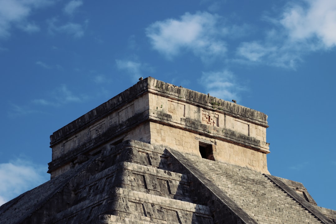 a very tall pyramid with a sky background,