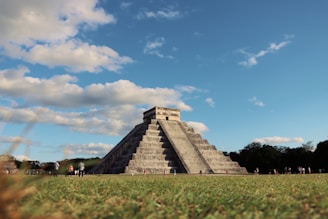 a group of people standing in front of a pyramid