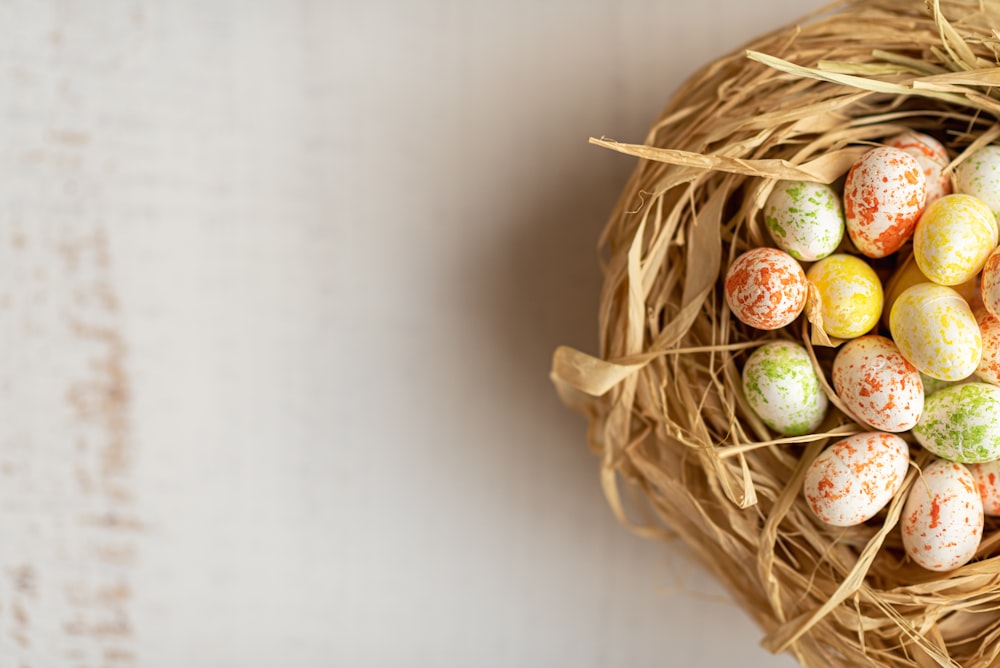 a bird nest filled with eggs on top of a table