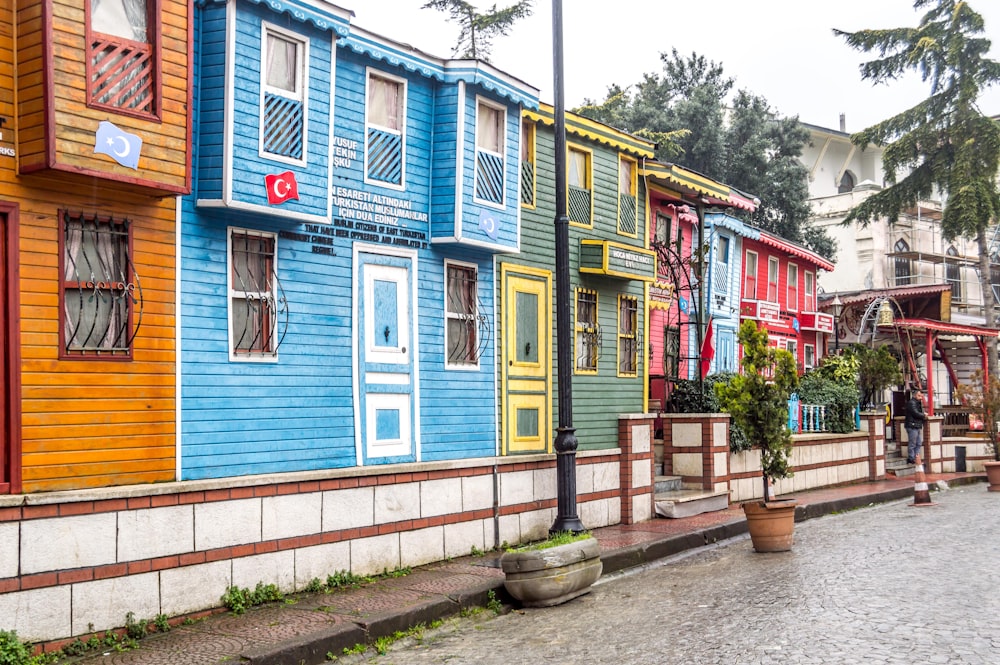 a row of colorful wooden houses on a street