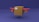 A cardboard box is designed to resemble an airplane, featuring red wings and propellers on either side. The background is a deep blue shade, contrasting with the brown box and red elements.