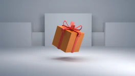 an orange gift box with a red bow