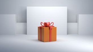 A neatly wrapped orange gift box is adorned with a bright red ribbon and bow. The gift is placed against a minimalist white background with geometric shapes.