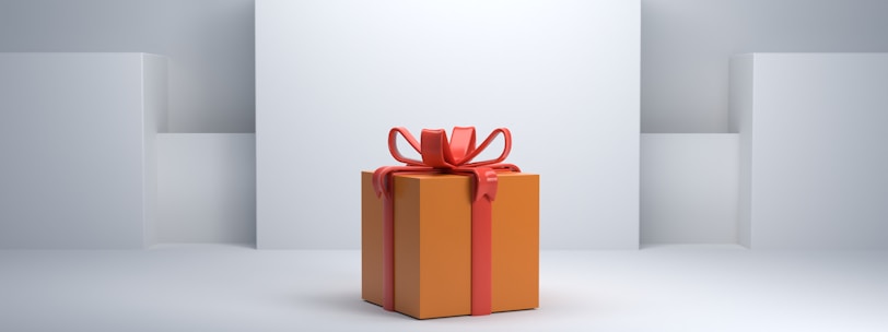 an orange gift box with a red bow