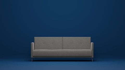 a gray couch against a blue wall