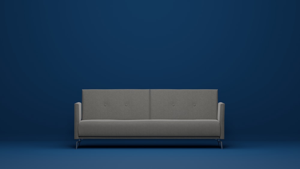 青い壁に灰色のソファ