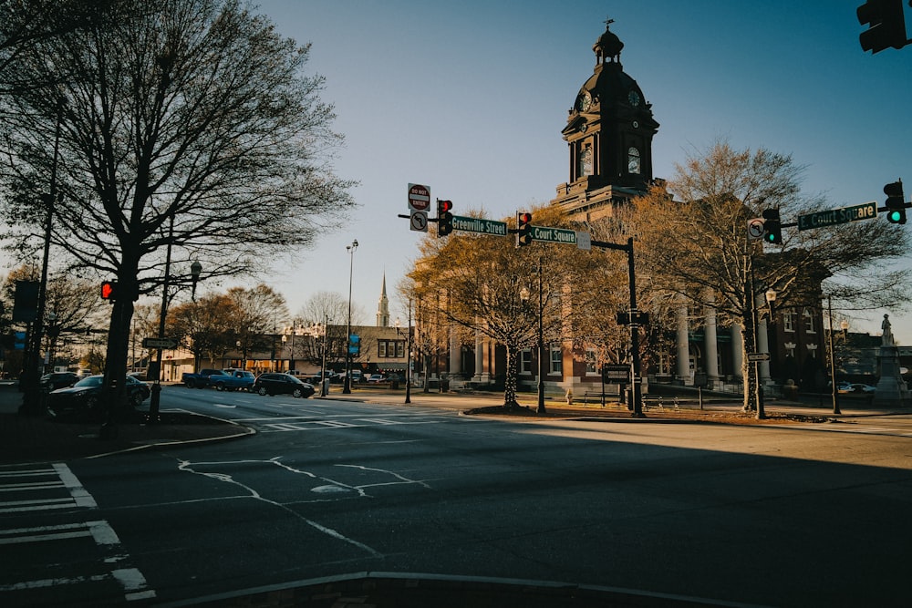 a city street with traffic lights and a tall building