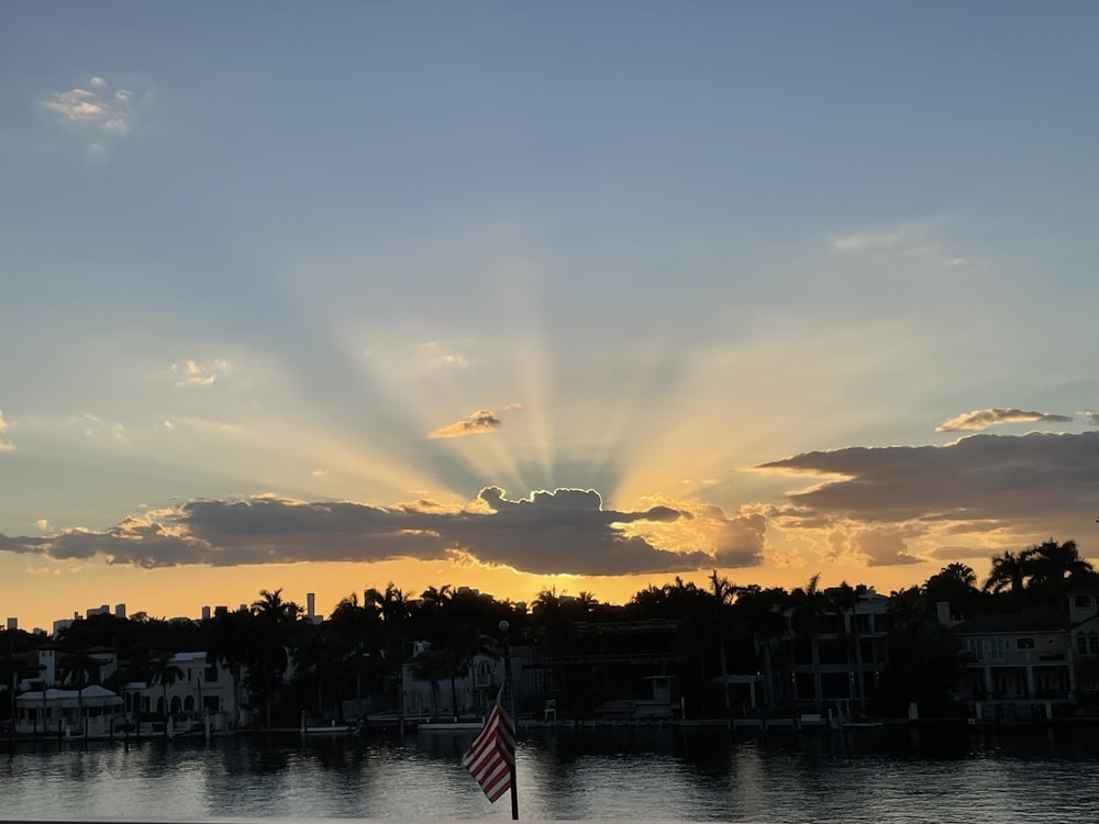 the sun is shining through the clouds over the water