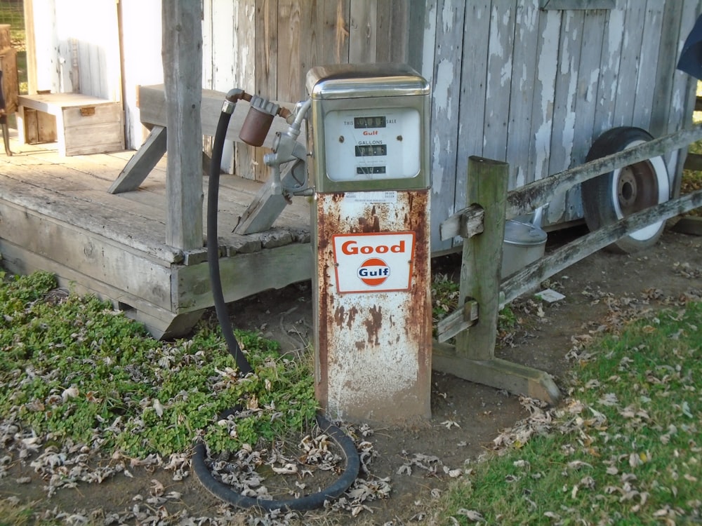 an old gas pump sitting in front of a building