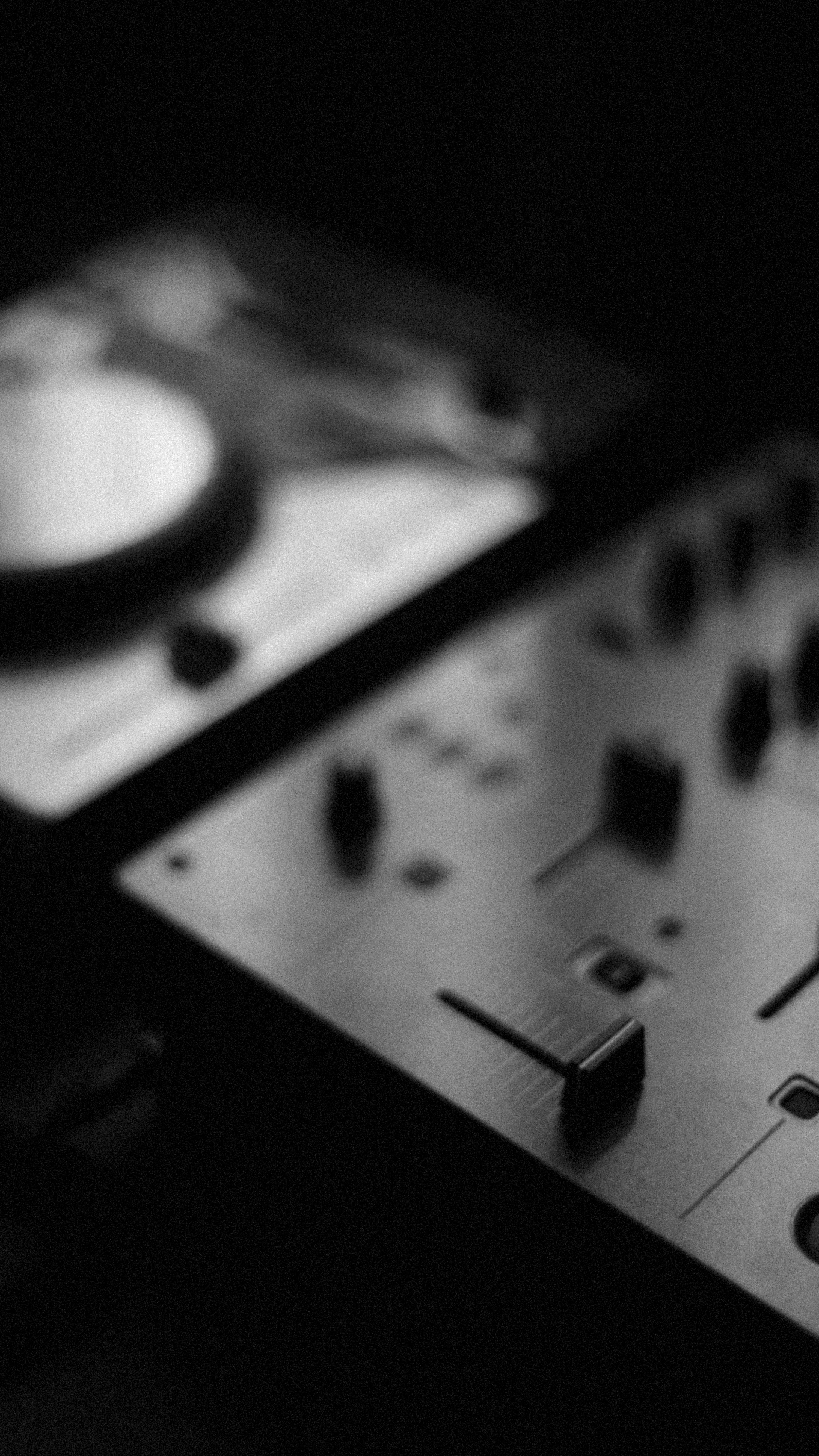 a black and white photo of a mixing console