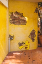 a yellow wall with a cartoon character painted on it