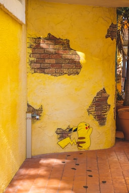 a yellow wall with a cartoon character painted on it