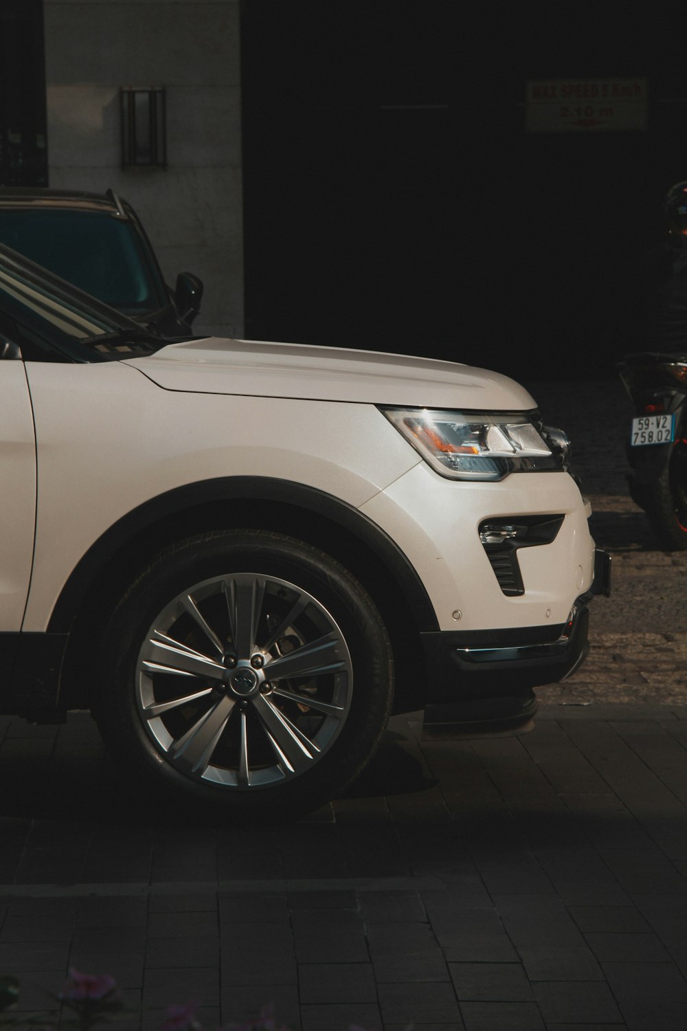 a white suv parked in front of a building