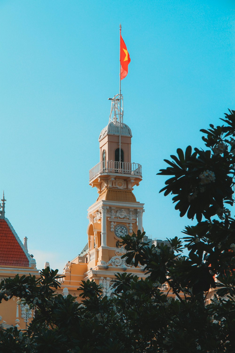 a clock tower with a flag on top of it