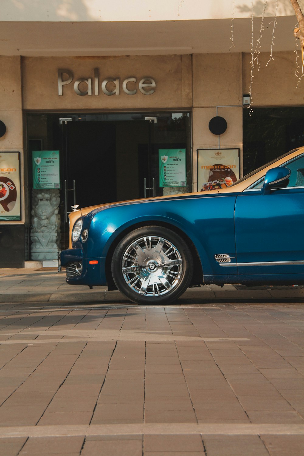 a blue car parked in front of a building