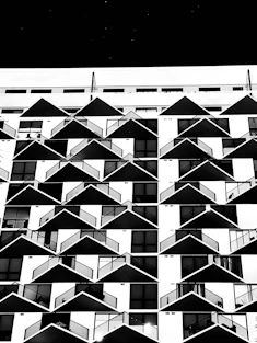 a black and white photo of a building with balconies