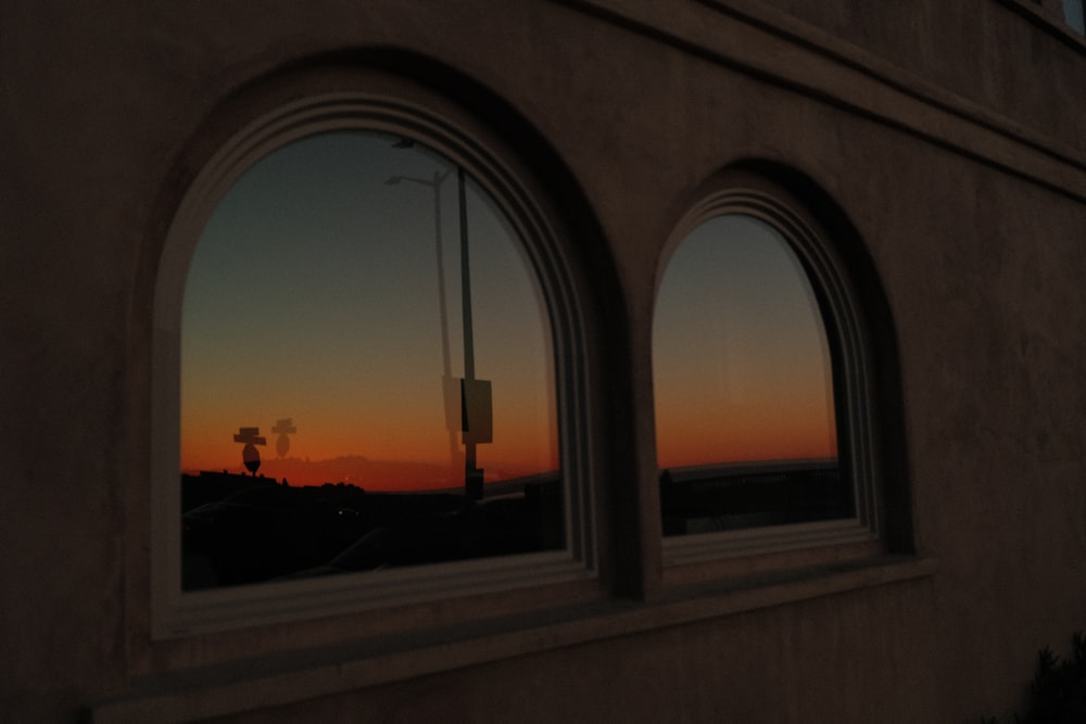 a sunset seen through three windows of a building
