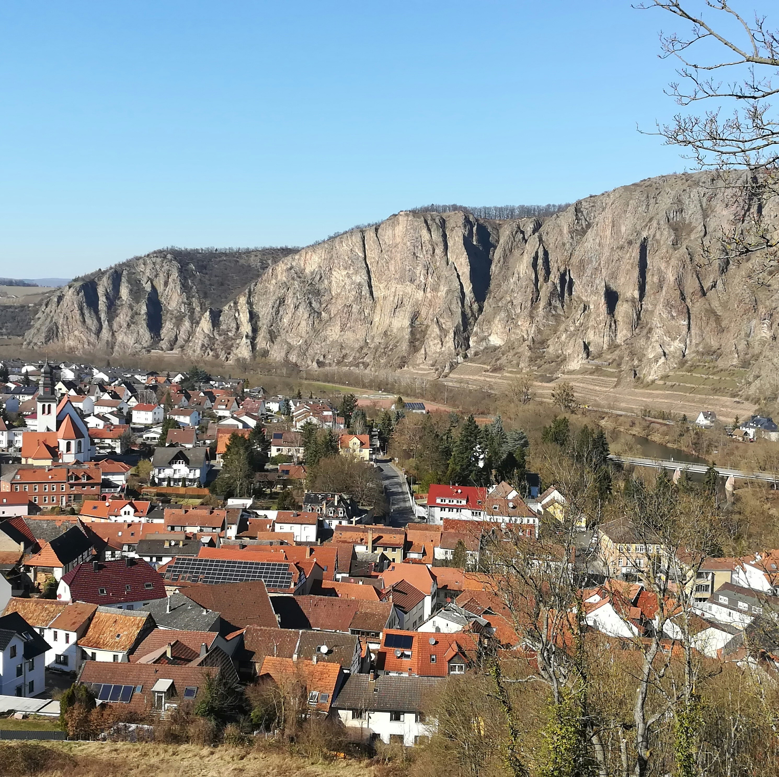 a village in the mountains with a mountain in the background