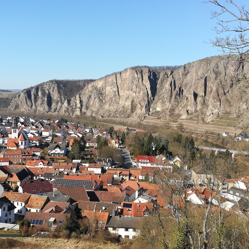 a village in the mountains with a mountain in the background