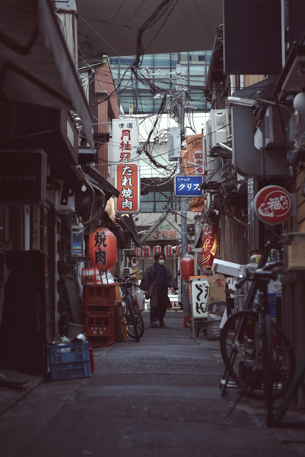 a man walking down a narrow alley way