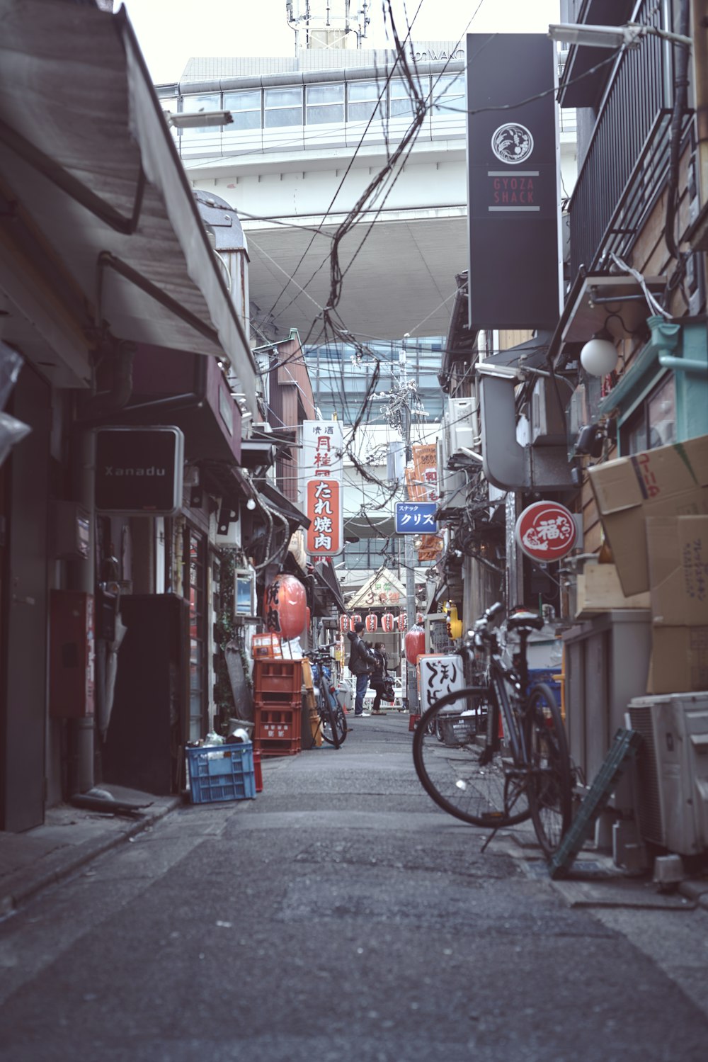 a narrow city street with a bike parked on the side of it