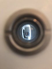 a close up of a toilet bowl with a reflection of a person in it