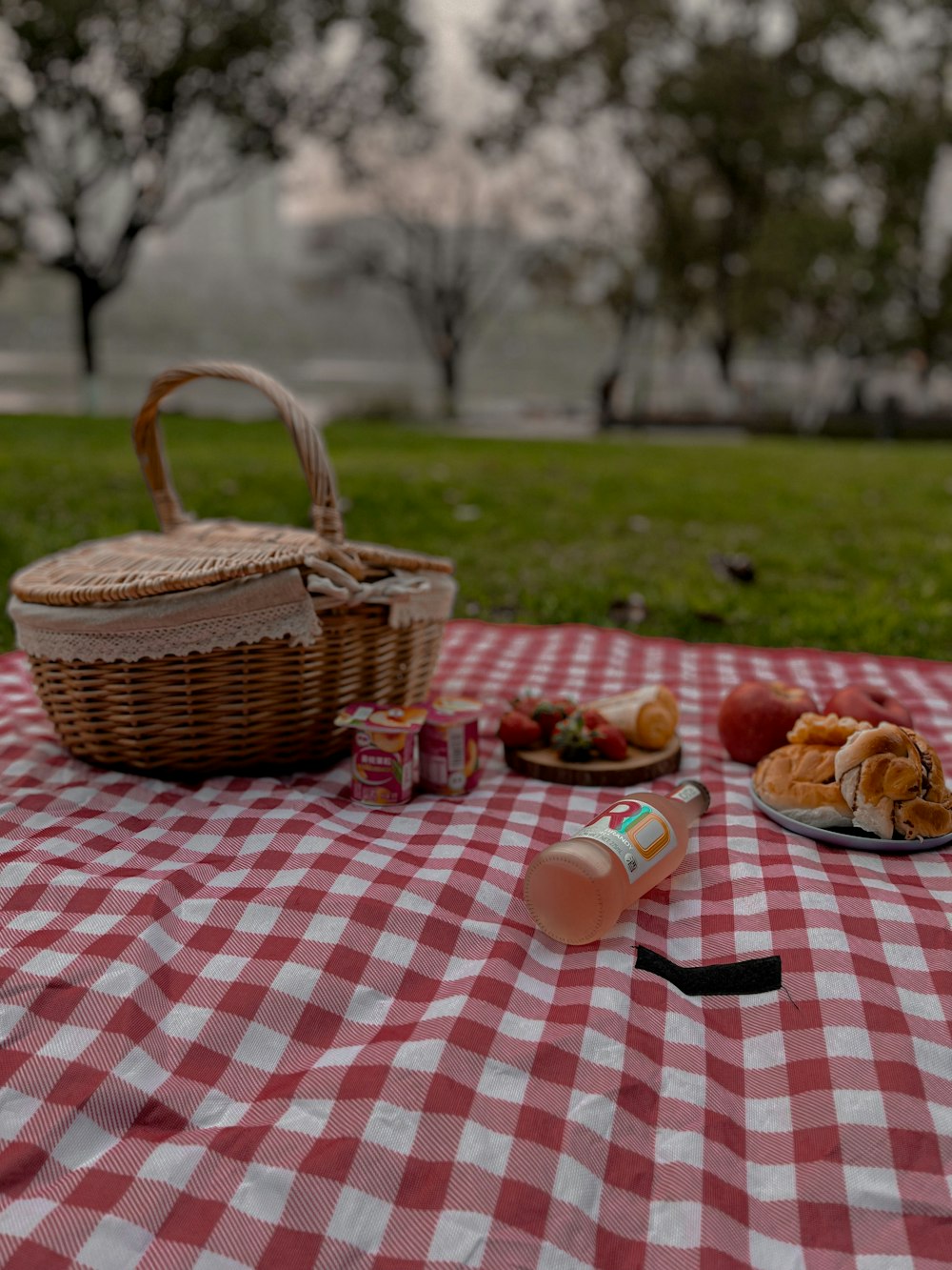 a picnic table with a basket of food on it