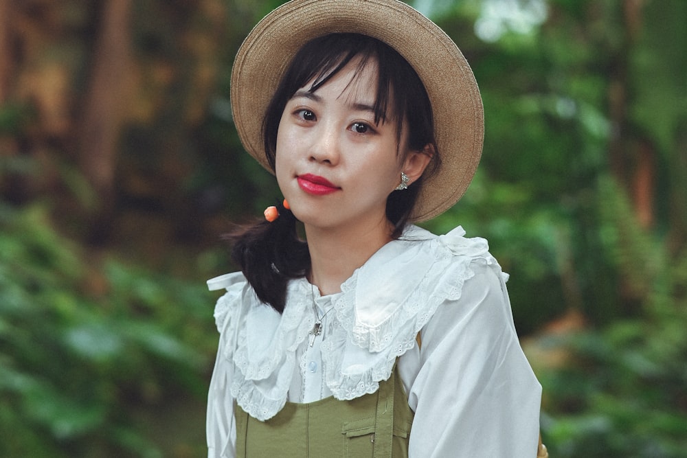 a woman wearing a hat and a green dress