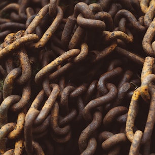 a pile of rusty chains sitting on top of a wooden table