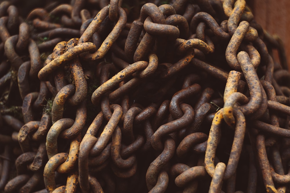 a pile of rusty chains sitting on top of a wooden table