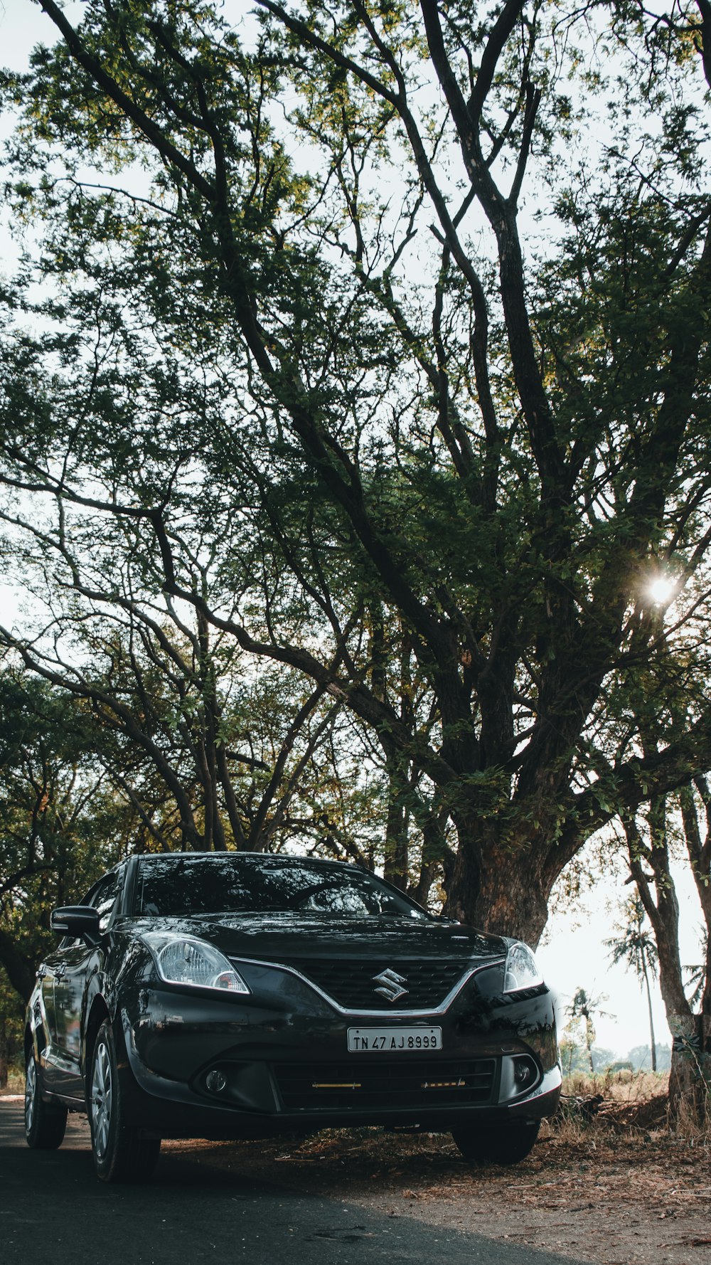 a black car parked on the side of the road