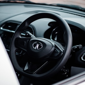 a close up of a steering wheel and dashboard of a car