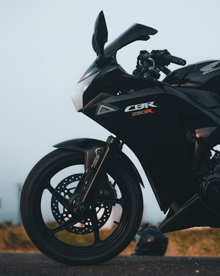 a black motorcycle parked on the side of the road
