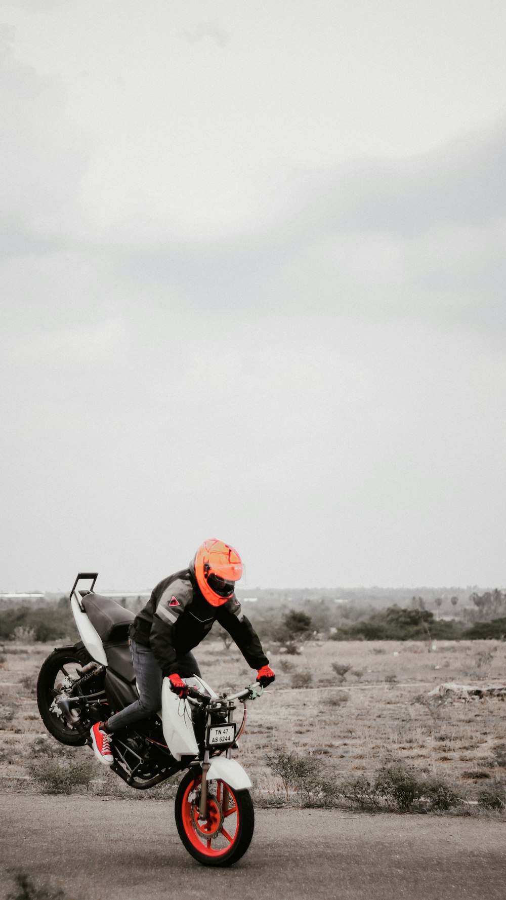 a man riding a motorcycle on top of a dirt road