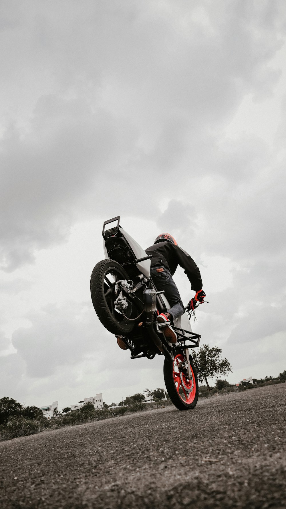 a person on a motorcycle doing a trick in the air