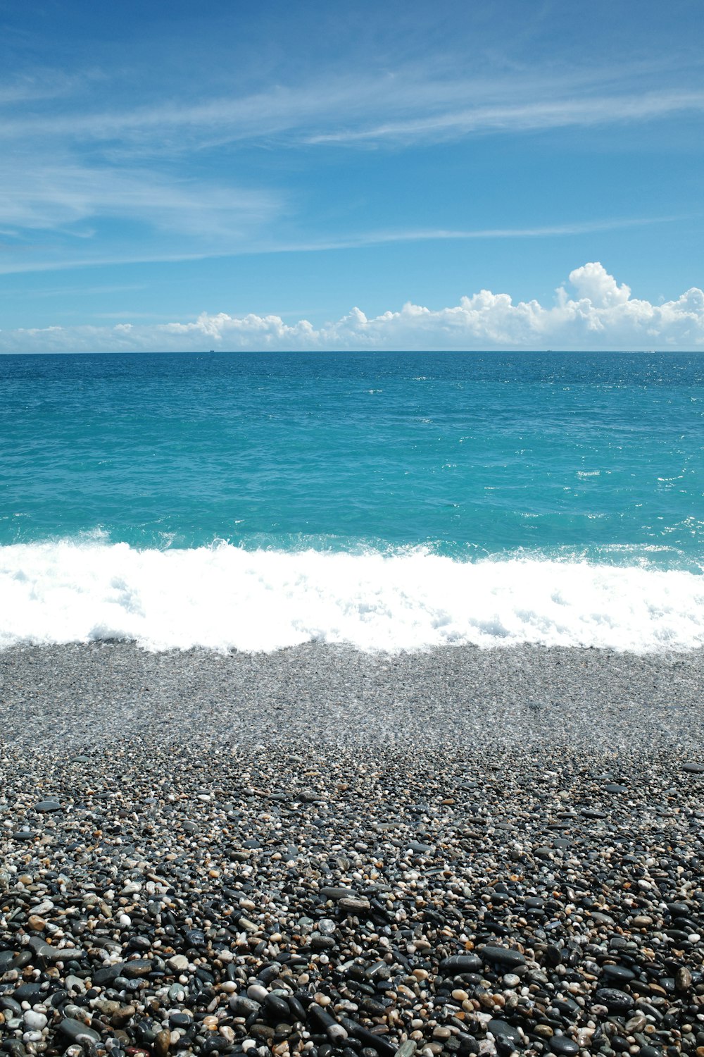 a view of the ocean from a rocky beach