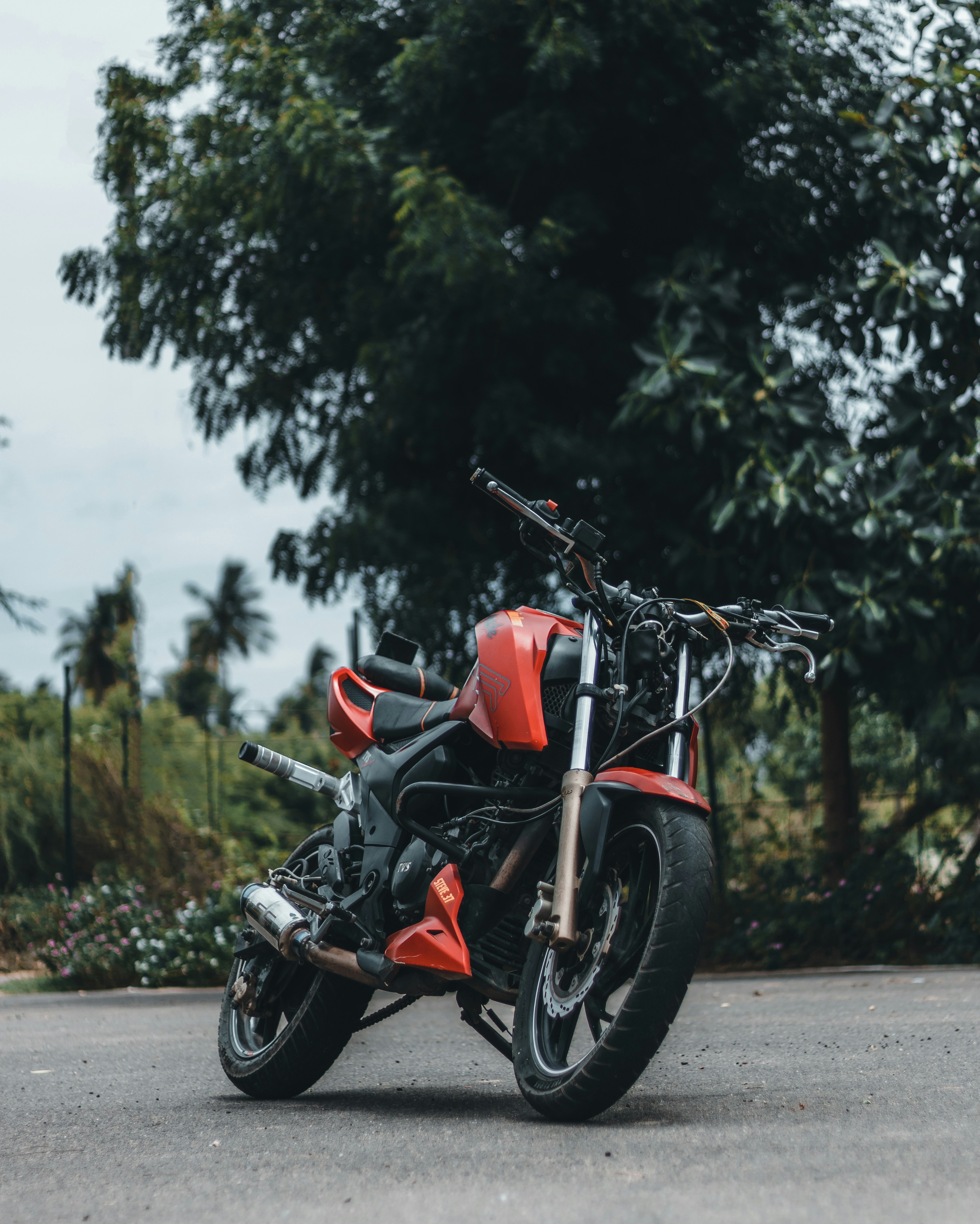 a red motorcycle parked on the side of the road