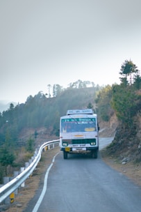 A spacious premium shuttle bus driving along a scenic Norwegian fjord road.