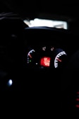 A close-up of a car dashboard with illuminated controls.