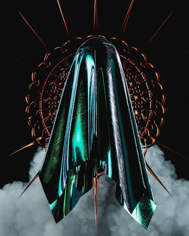 A metallic, futuristic structure with sharp, pointed edges is set against a dark background, surrounded by swirling smoke. The central element displays a glossy sheen with turquoise and black hues reflecting light, while circular, spiked patterns radiate from it.