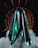 A metallic, futuristic structure with sharp, pointed edges is set against a dark background, surrounded by swirling smoke. The central element displays a glossy sheen with turquoise and black hues reflecting light, while circular, spiked patterns radiate from it.