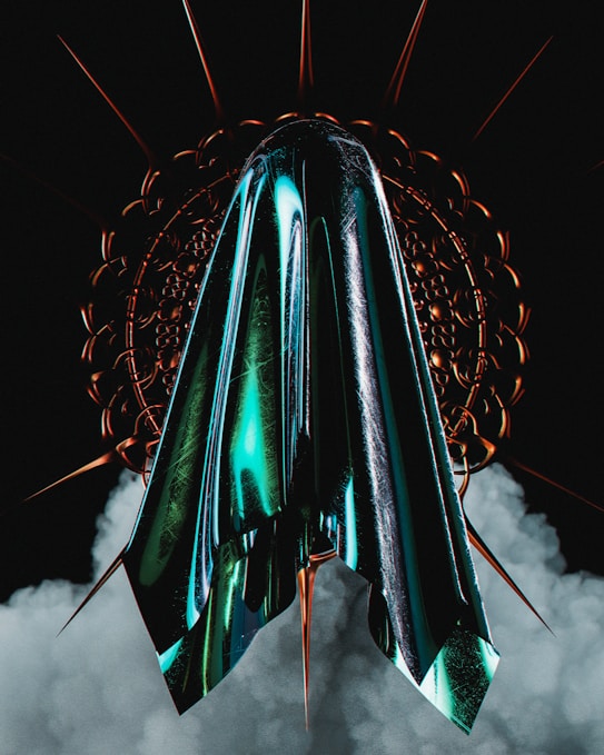 A metallic, futuristic structure with sharp, pointed edges is set against a dark background, surrounded by swirling smoke. The central element displays a glossy sheen with turquoise and black hues reflecting light, while circular, spiked patterns radiate from it.