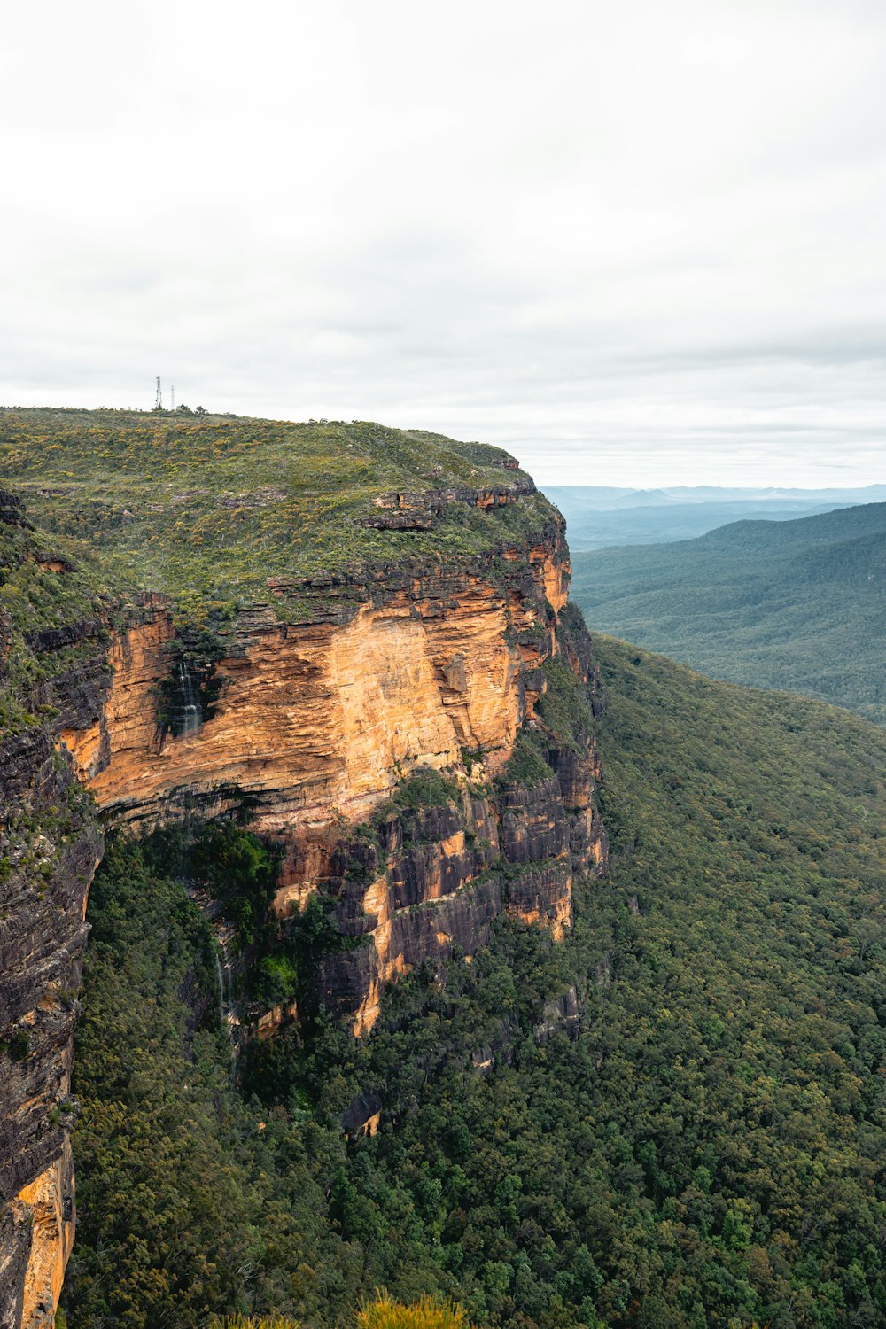 a view of a mountain with a cliff in the foreground