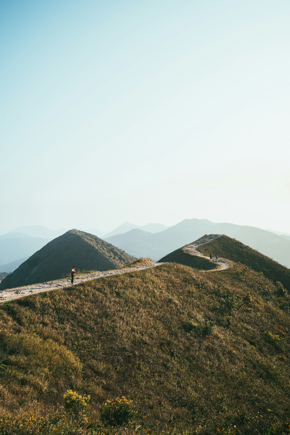 a couple of people that are walking down a hill