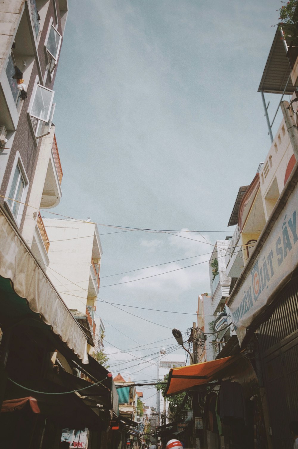 a narrow city street with a sky background