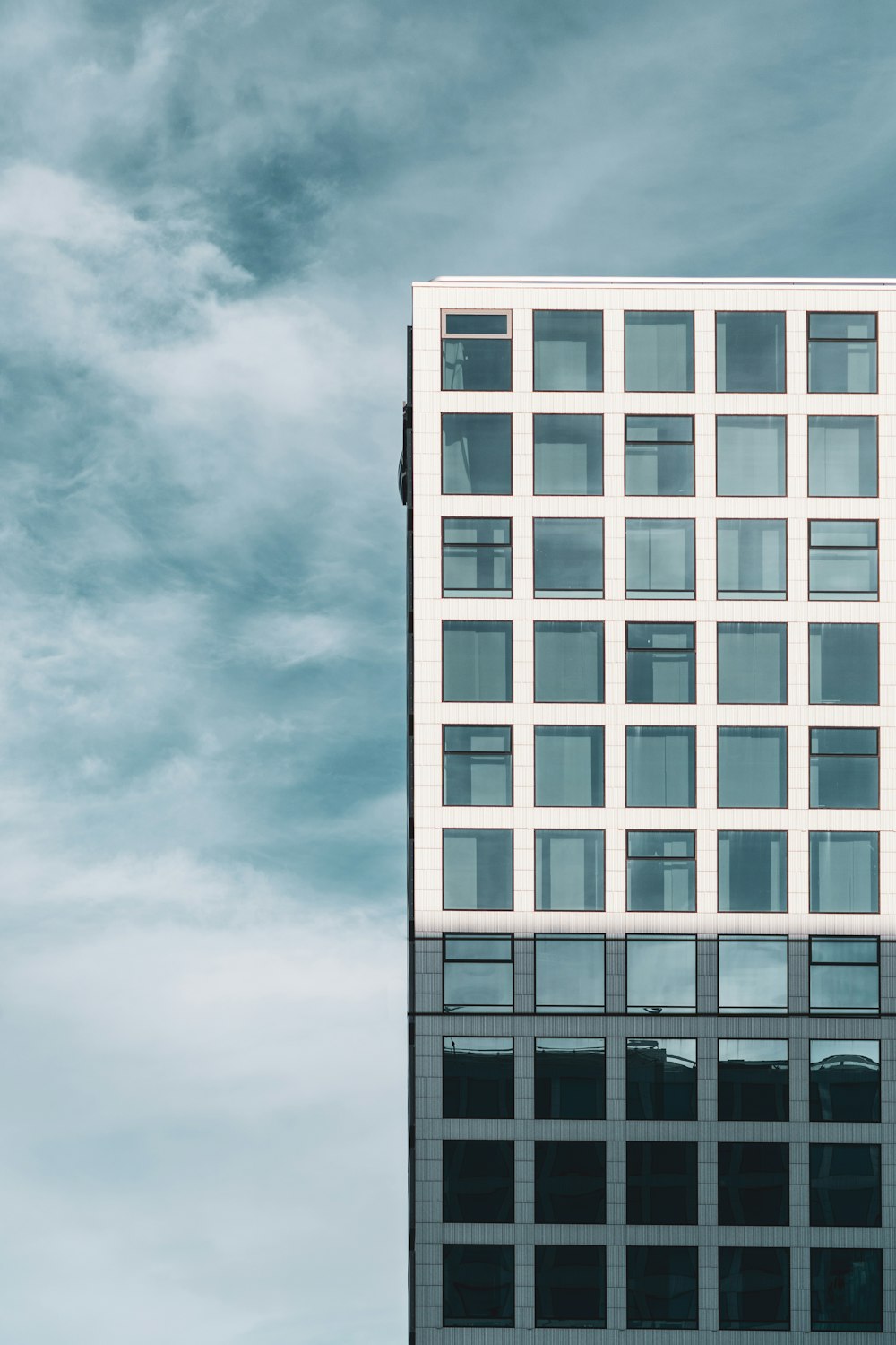 a tall white building with lots of windows