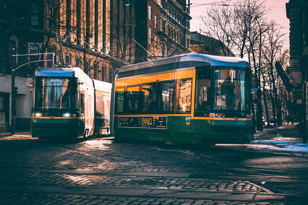 a couple of trains that are sitting on a street