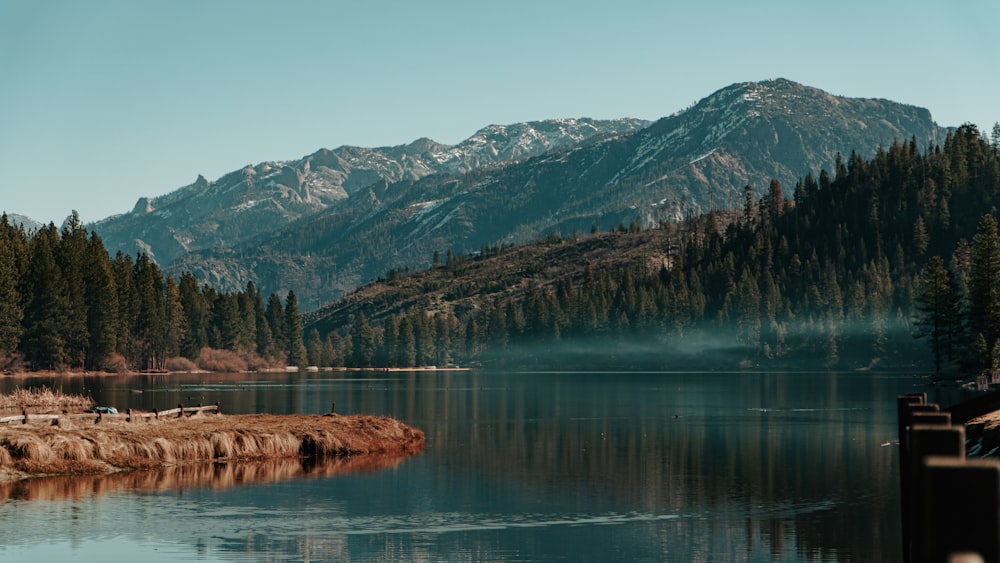 a body of water with mountains in the background