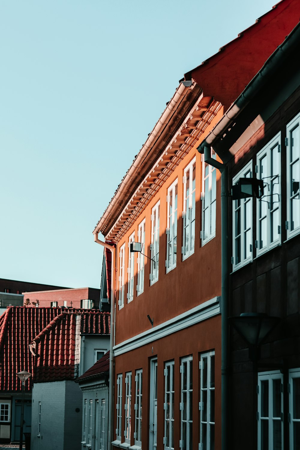 a red building with a clock on the side of it